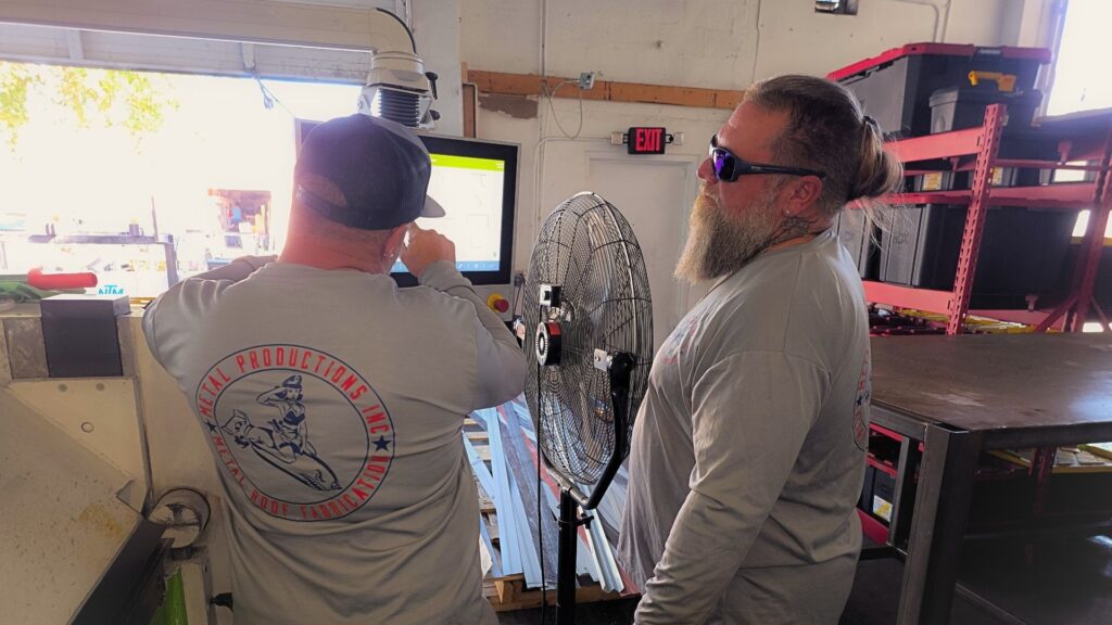 Roofing contractors waiting on delayed metal roofing materials at commercial job site