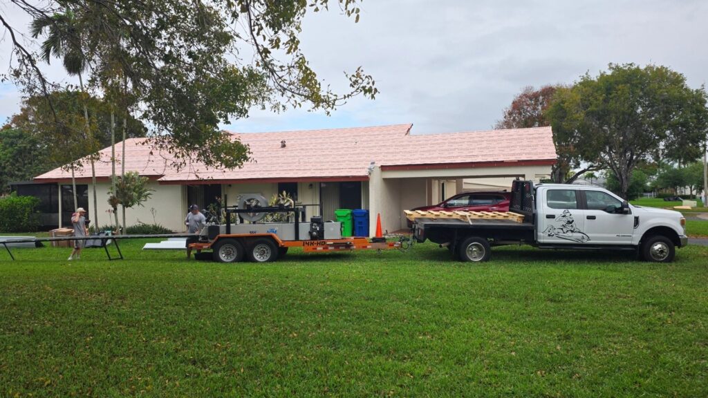 Roofing contractors inspecting misaligned standing seam metal panels on commercial roof