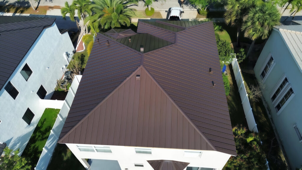 Roofing contractors installing Murica 150MS standing seam metal roofing system on commercial building